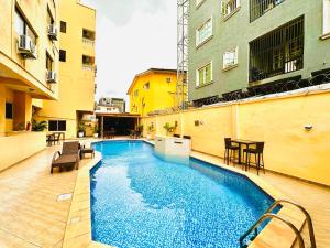 a swimming pool in the middle of a building at Presken Hotel Fajodd-4, Allen, Ikeja, Lagos in Ikeja