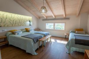 a bedroom with two beds and a window at La Casita de Melón in Suances