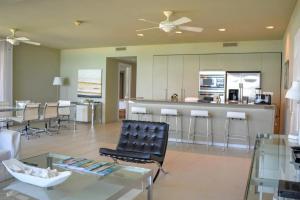 a living room with a bar and a kitchen at Le Vele Resort in Providenciales