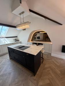 a kitchen with a large island in the middle at Oat & Olive Apartments - Alnwick in Alnwick