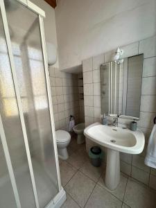 a bathroom with a shower and a sink and a toilet at Hour Home in Iglesias