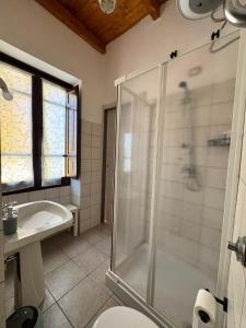 a bathroom with a shower and a toilet and a sink at Hour Home in Iglesias