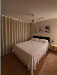 a bedroom with a bed with a white bedspread at CasaMare in Cariacica