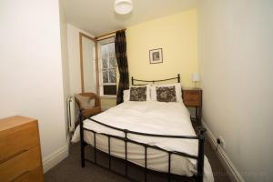 a bedroom with a bed and a window at Belle Vue Terrace Apartment in Great Malvern