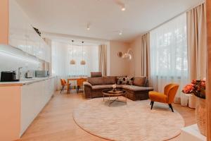 a living room with a couch and a table at Villa Garden Apartments in Poprad