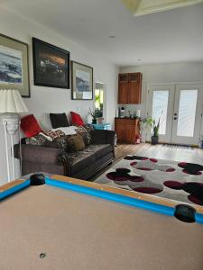 a living room with a couch and a pool table at The Cozy Nook in Grand Forks