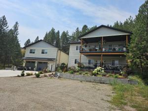a large house with a balcony and a driveway at The Cozy Nook in Grand Forks