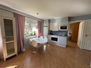 a kitchen with a table and chairs in a room at Ekängens vandrarhem in Virserum