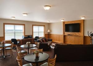a living room with furniture and a flat screen tv at Tumbleweed Inn & Suites in Alexander