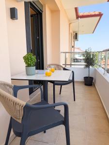 a table and chairs on the balcony of a building at Elia Stay in Kalives Poligirou