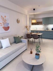 a living room with a couch and a table at Elia Stay in Kalives Poligirou