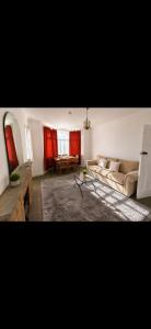 a living room with a couch and a table at Riverside all for you in Kingston upon Thames