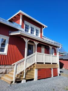 a red house with a porch and stairs on it at Villa Catharina in Kristinestad