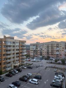 a parking lot with cars parked in front of buildings at Elite Suites - Vogošća in Vogošća