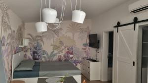 a bedroom with a bed with a floral wallpaper at Peaceful Cherry Place in Portorož