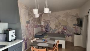 a small room with a dining table and a kitchen at Peaceful Cherry Place in Portorož