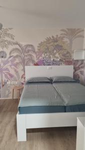 a white bed in a bedroom with a wall at Peaceful Cherry Place in Portorož +46 photos