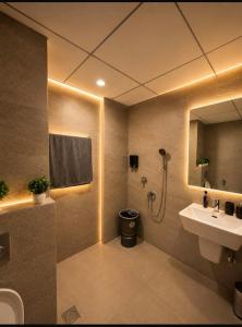 a bathroom with a sink and a shower and a toilet at Royal Stays in Greater Noida