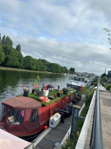 a boat is docked at a dock on a river at Riverside all for you in Kingston upon Thames