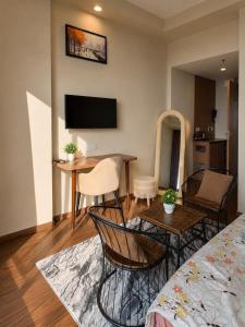 a living room with a bed and a table and chairs at Royal Stays in Greater Noida