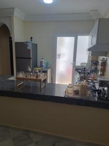 a kitchen with a counter with glasses on it at Dar hicham in Hajreien