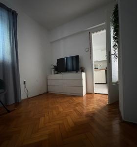 a living room with a flat screen tv on a dresser at Apartment Rose in Portorož
