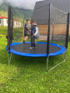 two people are playing on a trampoline at Sunny Side Cottage in Kazbegi