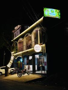 a building with a sign on the side of it at The Loop - Auroville Main Junction, 5-Minute Drive to Auroville Beach & ECR Road, High-Speed WiFi & Free Parking in Pondicherry