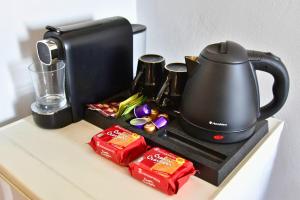 a tea kettle on top of a counter with food at Sam's Rooms in Vathí +13 photos