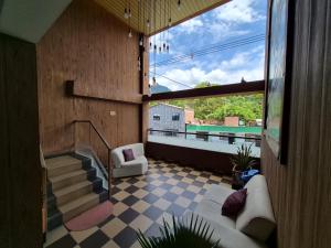 a living room with a view of a balcony at Hotel La Mansión in La Pintada