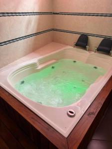 a jacuzzi tub with two chairs in it at Hotel La Mansión in La Pintada