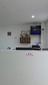 a room with a flat screen tv on the wall at Hotel San Cosme in Camaná