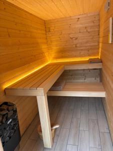 a wooden sauna with a bench in the middle at Las,Jezioro,Masaże,SPA in Ostrzyce +153 photos