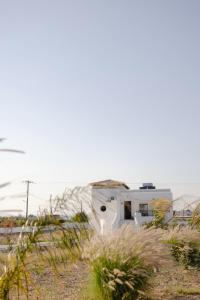 a white house in the middle of a field at Villa Helia in Kos