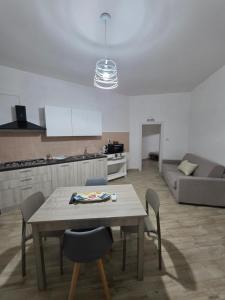a living room with a table and chairs and a couch at Puteoli Stop vacation home in Pozzuoli
