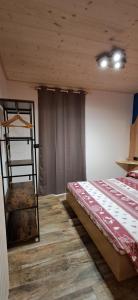 a bedroom with a bunk bed and a ladder at Appartamento Oserot in Bersezio