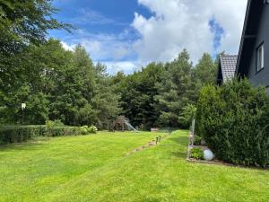 a large yard with a playground in the background at Las,Jezioro,Masaże,SPA in Ostrzyce