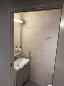 a bathroom with a sink and a mirror at Vierumäki Chalets 6 A4904 in Heinola +8 photos