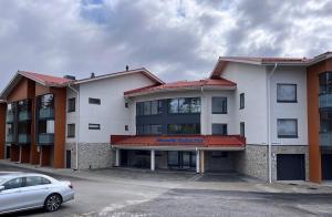 a building with a car parked in a parking lot at Vierumäki Chalets 6 A4904 in Heinola