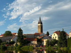 a town with a church with a clock tower at V srdci Telče - Apartmán in Telč