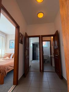 a bedroom with a door open to a bathroom at V srdci Telče - Apartmán in Telč