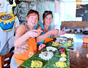 two women sitting at a table with food at Aryavilla Heritage in Varkala +18 photos