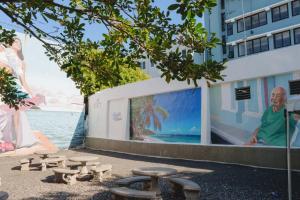 a group of picnic tables in front of a building at Elokut in San Juan