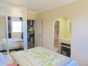 a bedroom with a bed and a bathroom with a mirror at U Closu San Petru in Linguizzetta +7 photos