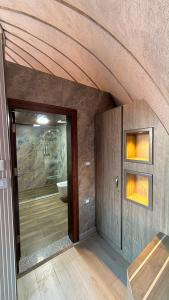 a bathroom with a large glass door with a toilet at Wadi Rum Bella Rose Luxury Camp in Disah +211 photos