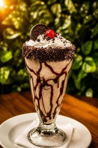 a chocolate milkshake on a plate on a table at Pousada Flor de Sal in Macau +22 photos