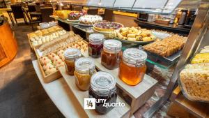 a display case in a bakery with various types of food at Edifício Praça Osório in Curitiba