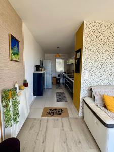a living room with a couch and a kitchen at ROOF TOP 50m2 VUE MER !! à 2 mn à pied de la PLAGE et de la THALASSOTHERAPIE ! in Concarneau
