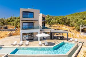 a villa with a swimming pool and a house at Villa Andria in Apolpaina