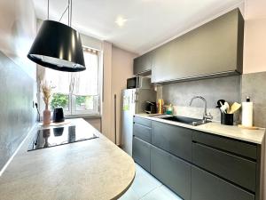 a kitchen with a sink and a counter top at La Parenthèse - Maison avec piscine privée in Wissembourg